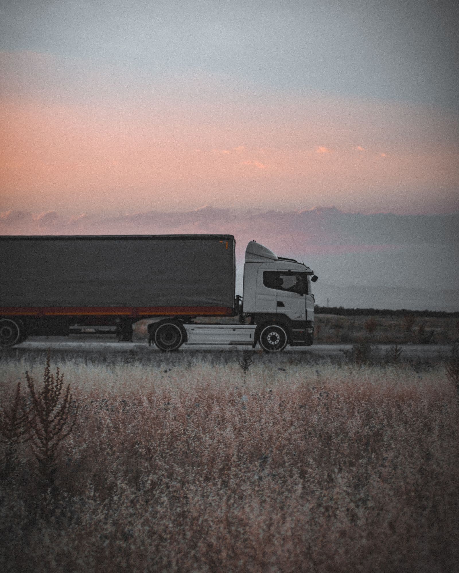 A haulage truck on the road at dusk — goods moving with D'trend Logistics.